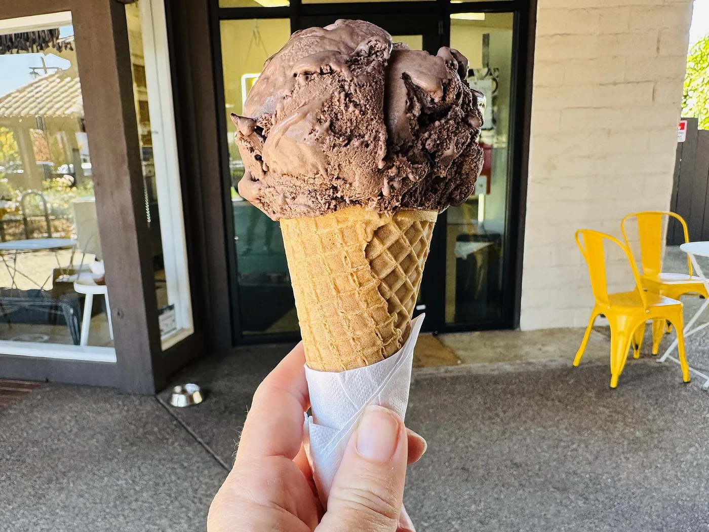 A scoop of chocolate ice cream on a sugar cone. The photo was not taken in Peachtree City.