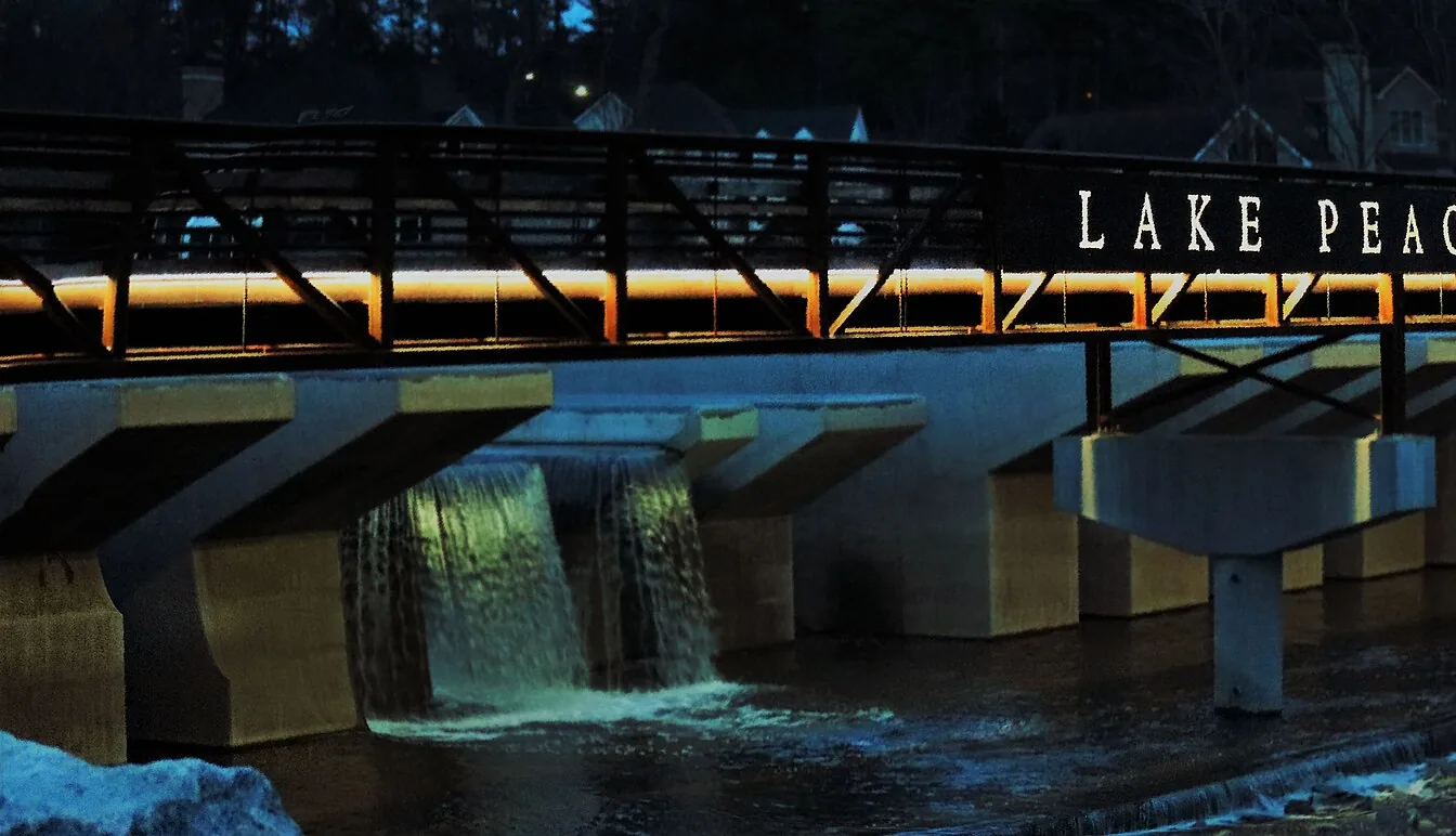 The lighted Lake Peachtree bridge at night in Peachtree City