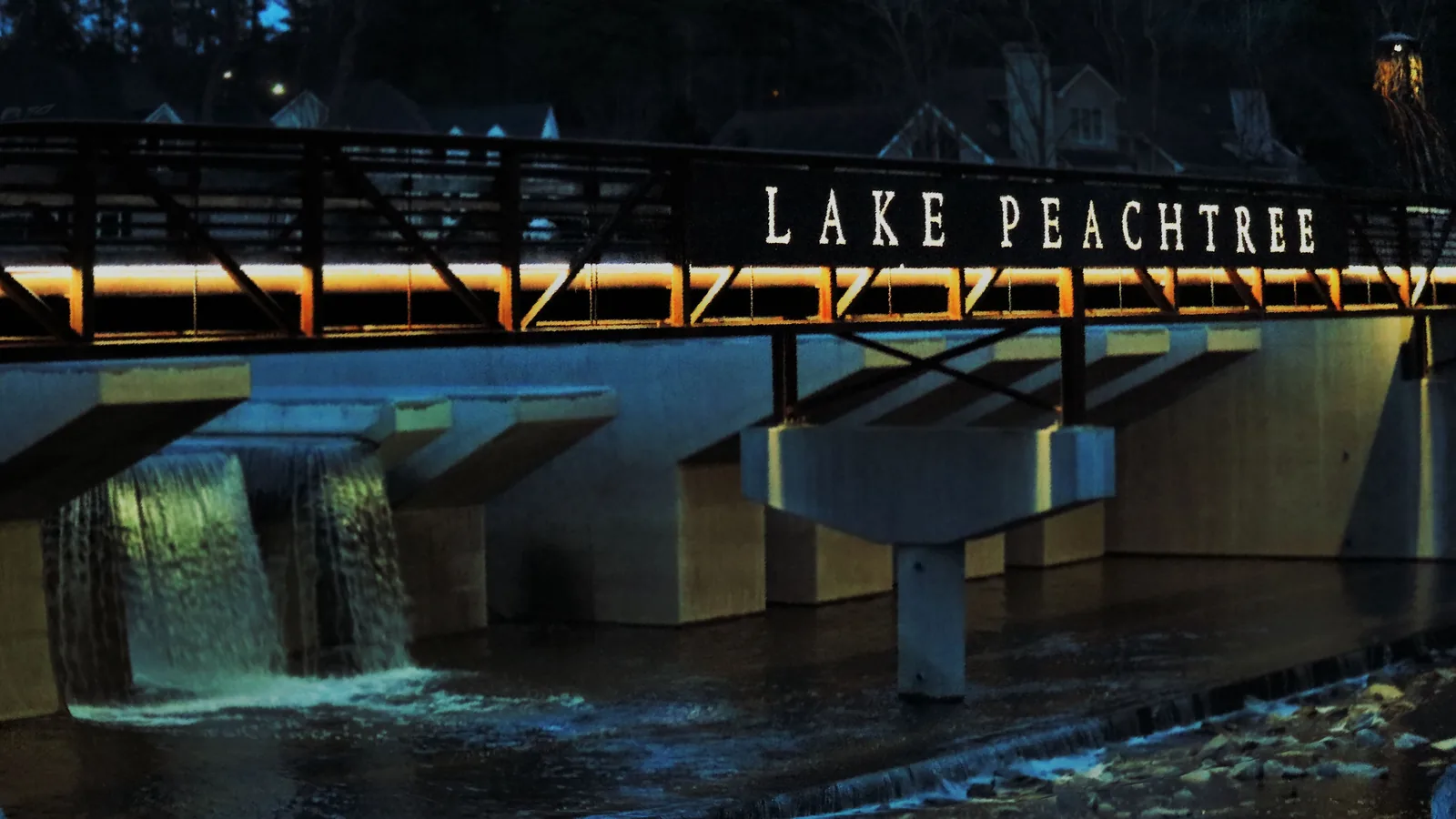 A bridge over Lake Peachtree at night, in Peachtree City