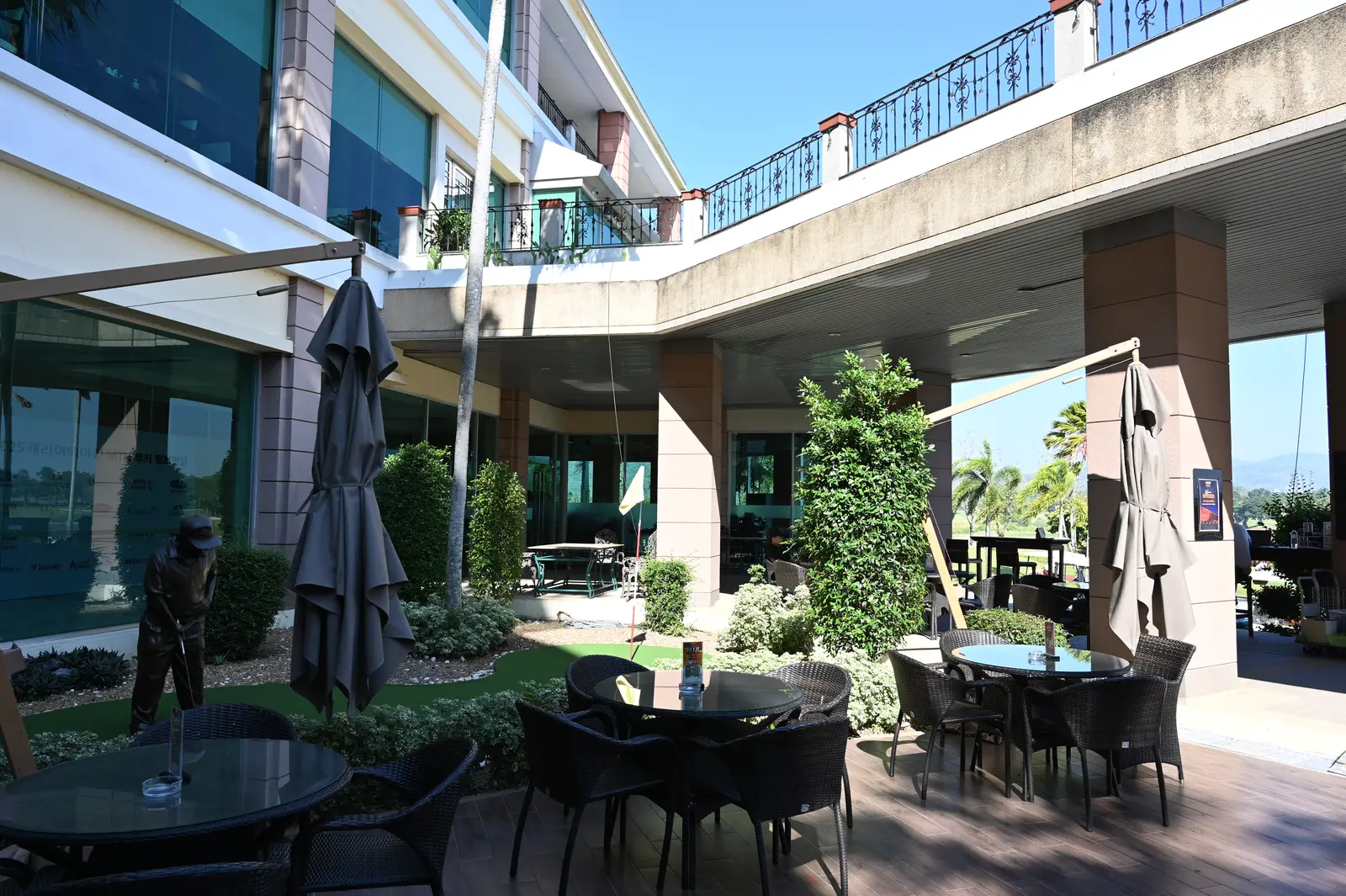 Tables and umbrellas on a cafe patio. The photo was not taken in Peachtree City.