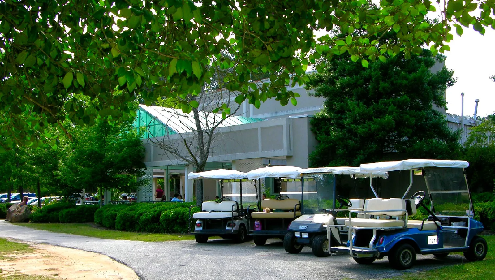 Golf carts parked by the path at Aberdeen Village Shopping Center in Peachtree City.
