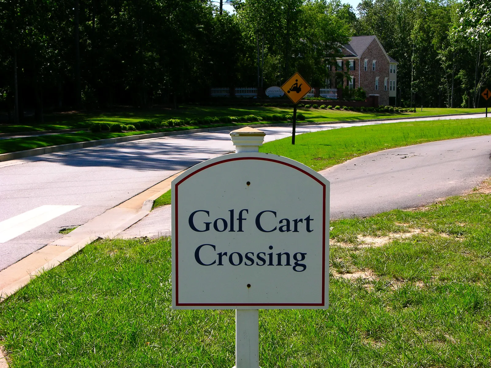 A golf cart crossing on the multi-use path at MacDuff Parkway in Peachtree City.